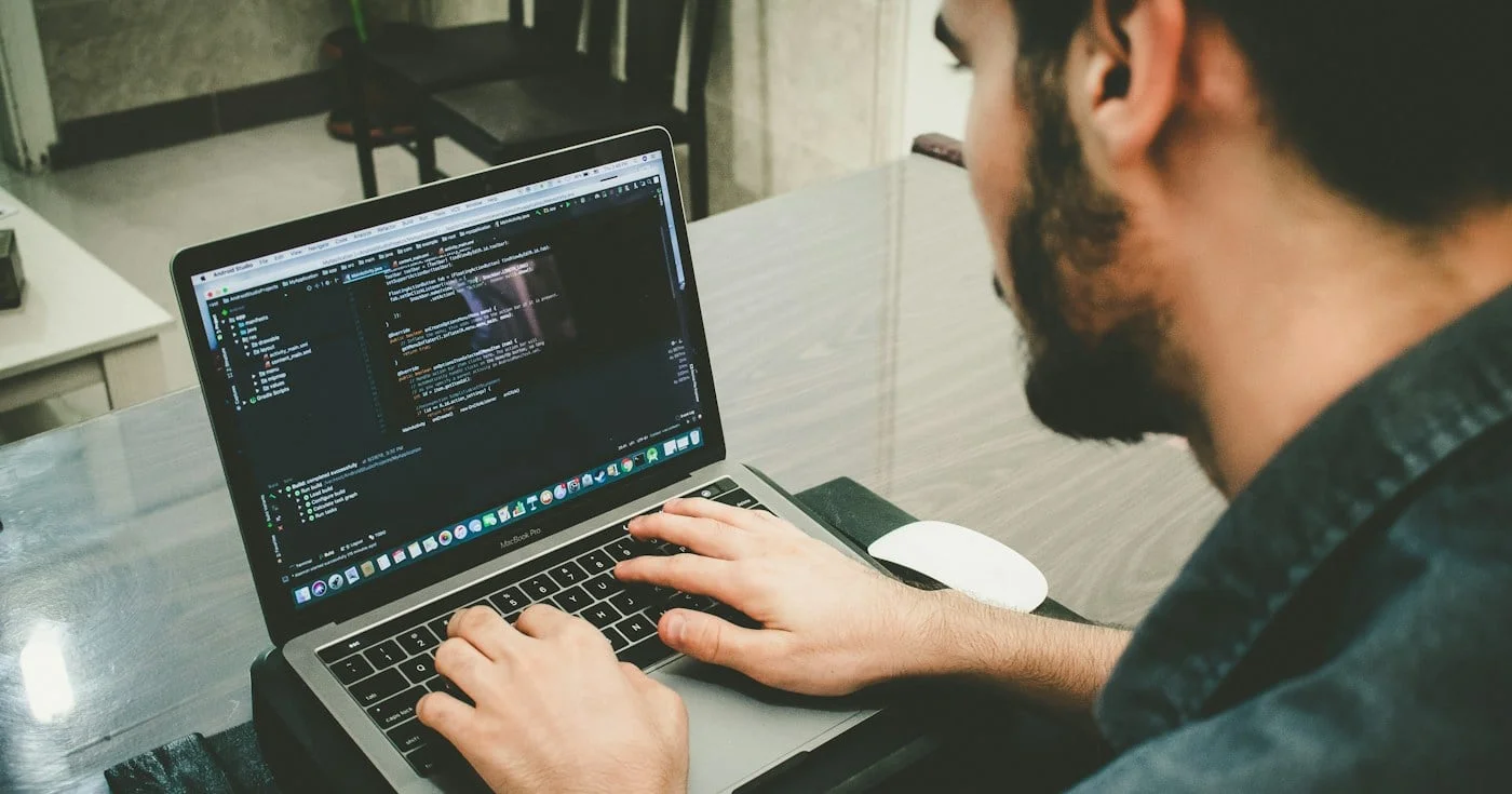 Engineer writing production code on a laptop